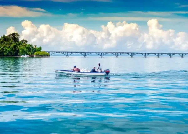 A group of people in a boat on the water.