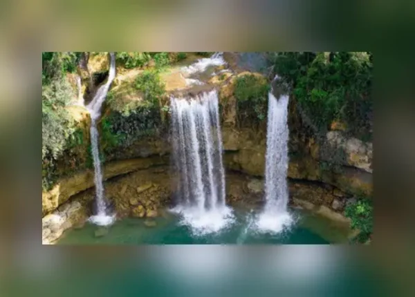 Three waterfalls in a body of water