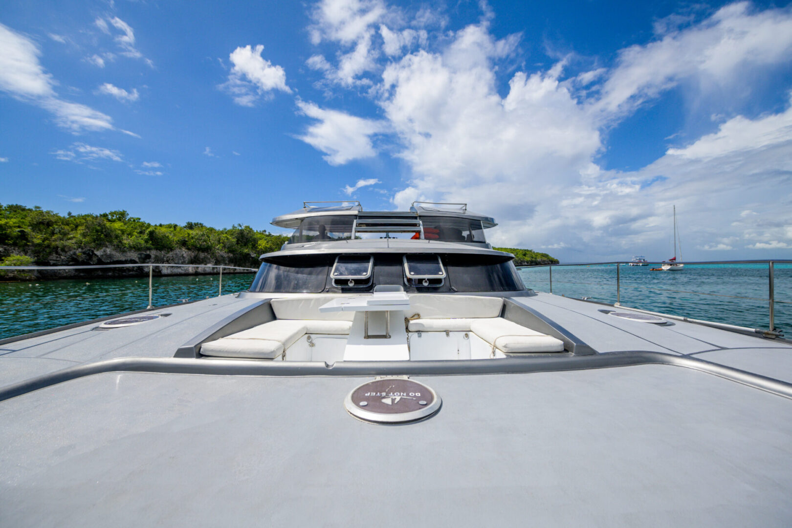 A large boat with a deck and seating area.