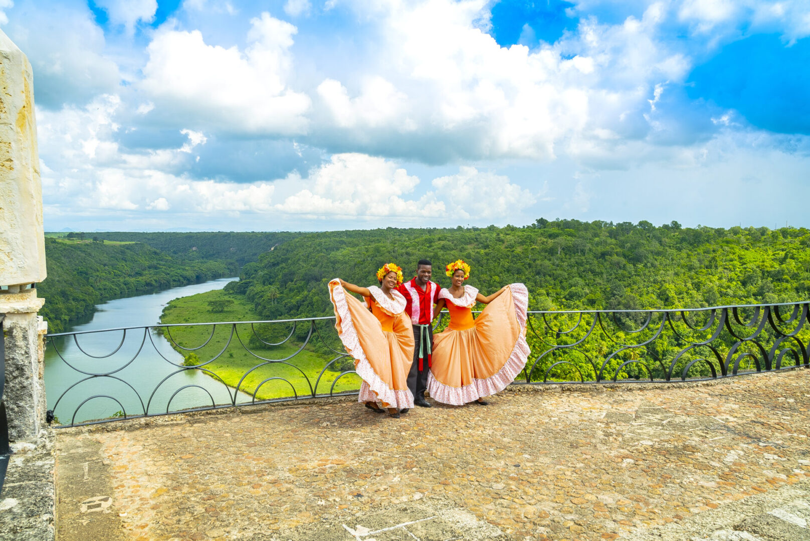 Two people standing on a hill with their arms around each other.