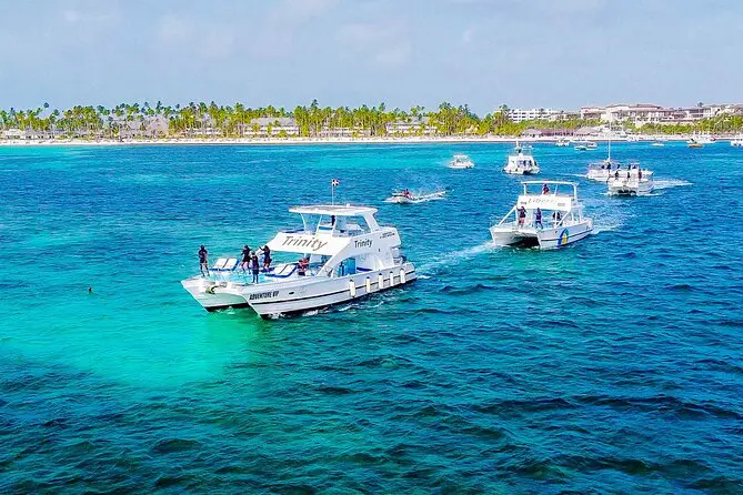 A group of boats floating on top of the ocean.