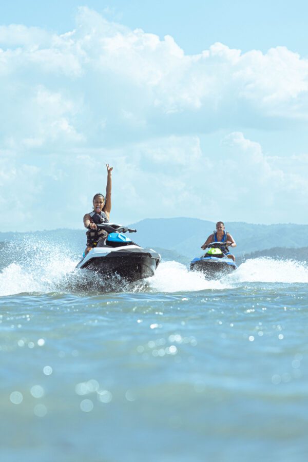 Two people on jet skis in the ocean.