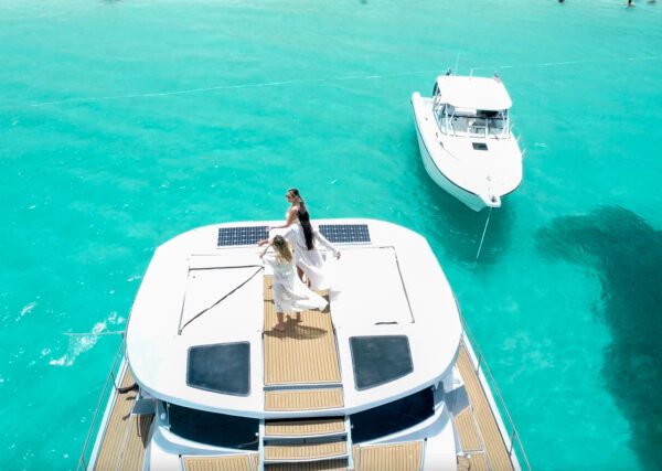 A couple is standing on the deck of their boat.