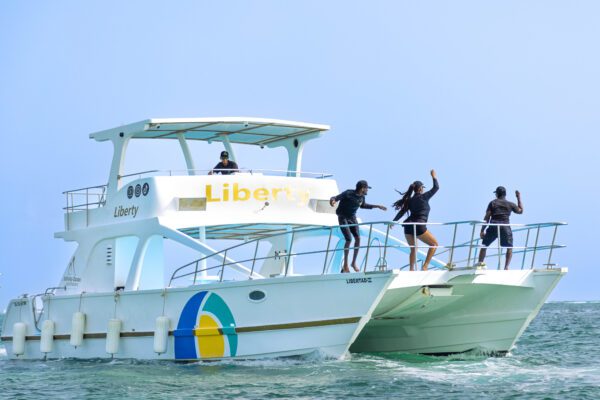 A group of people on the side of a boat.